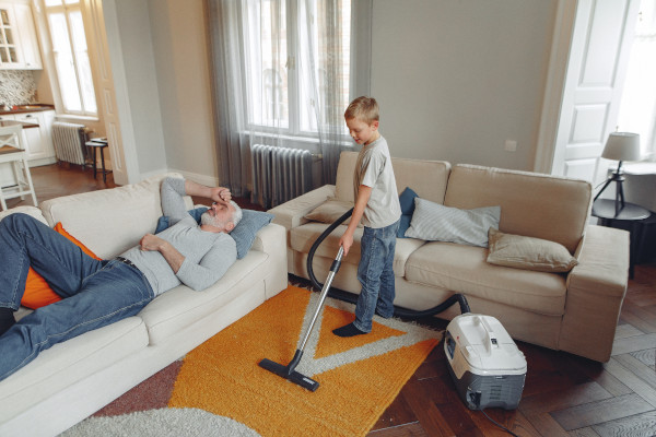 boy vacuuming rug